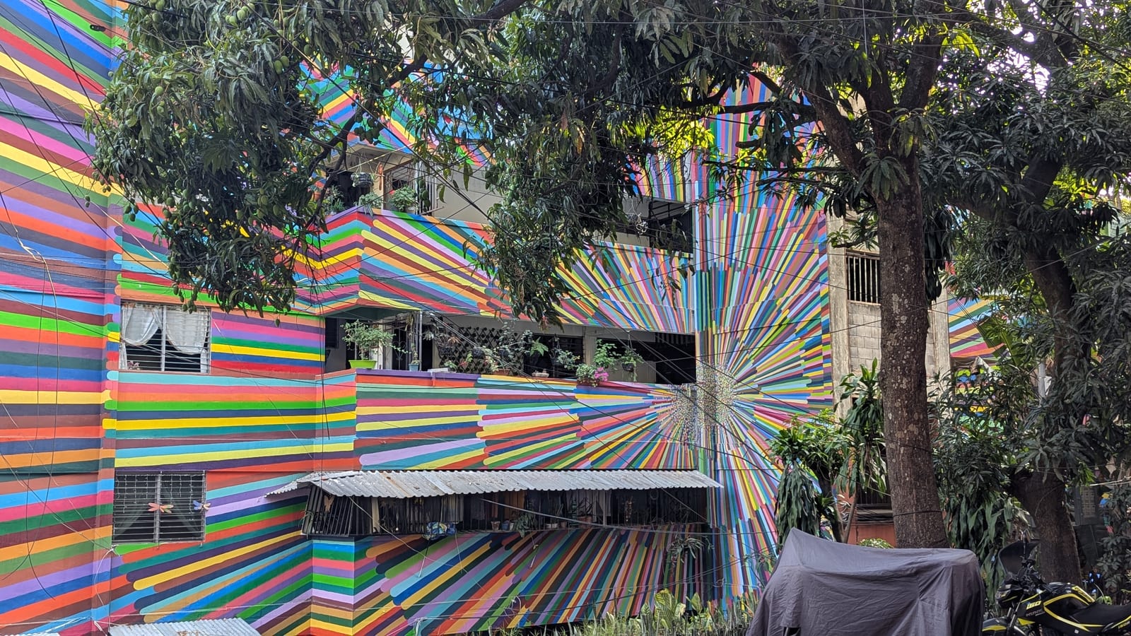 Brightly painted courtyard and railings in Zacamil