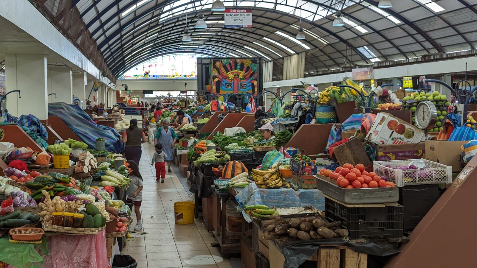 Produce stalls inside the 10 de Agosto market hall in Cuenca