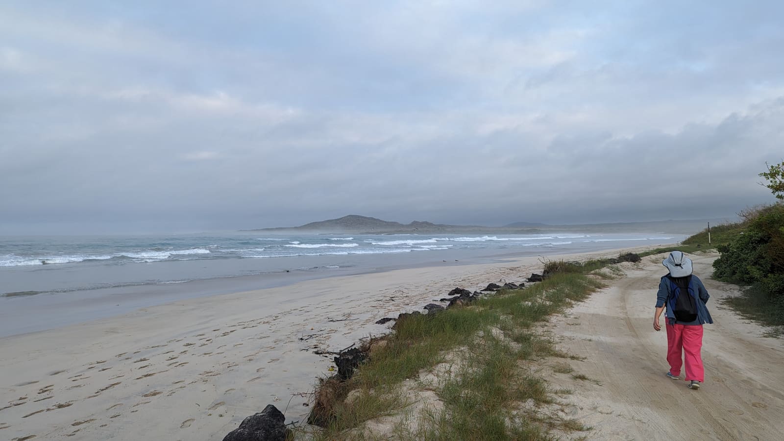 Long empty beach stretching along the Isabela shoreline in the morning
