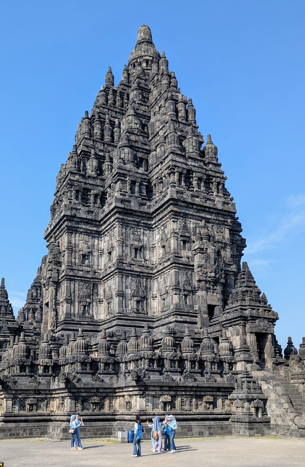 The tall central spire of Prambanan temple against the sky