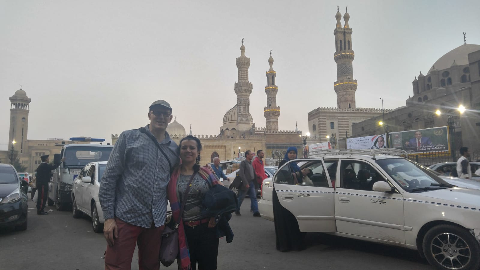Travelers with minarets rising behind them in Old Cairo