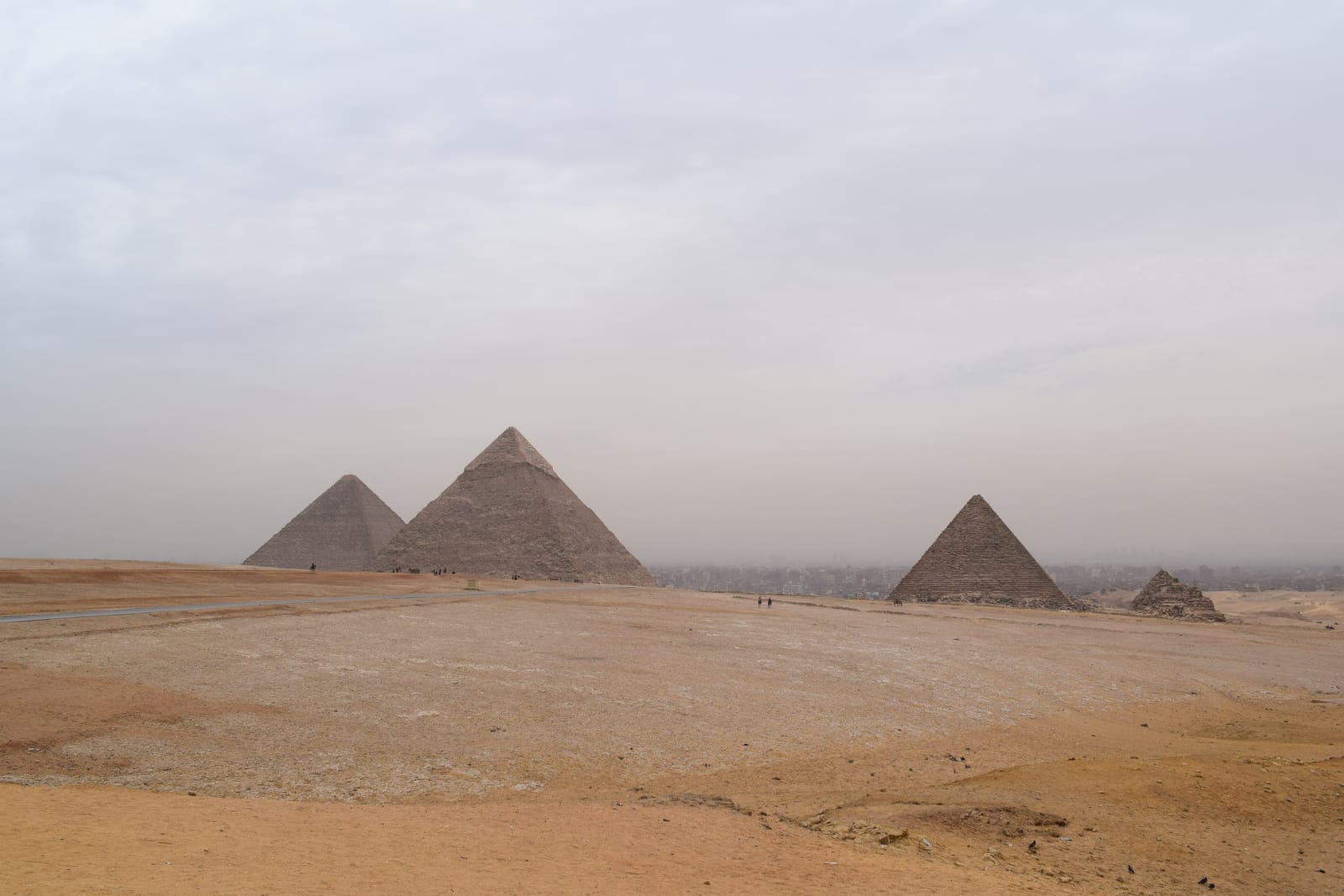 The three main pyramids of Giza seen across open desert