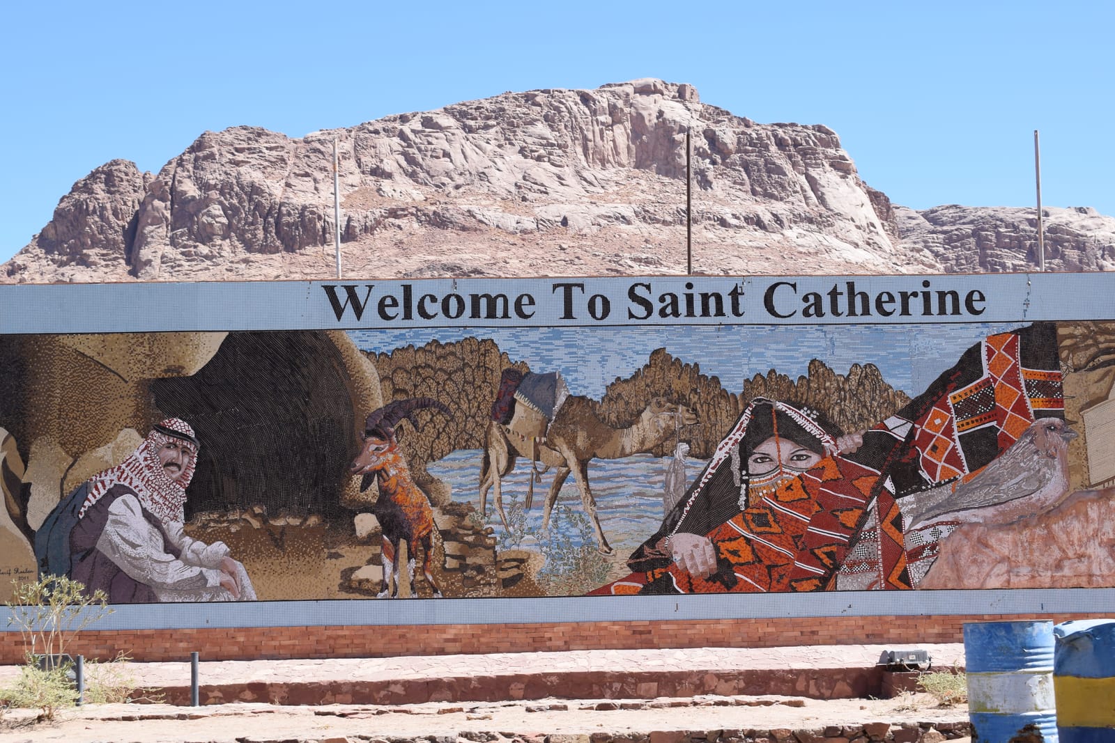 A Welcome to Saint Catherine sign painted with Bedouin and camel scenes
